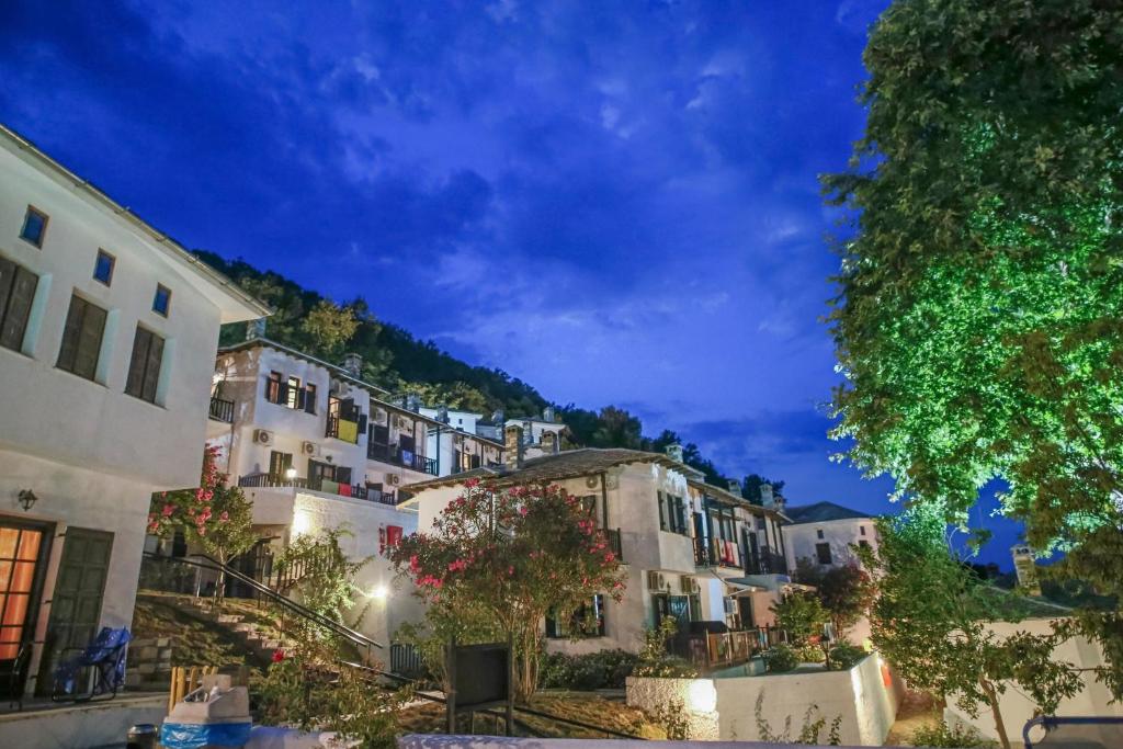 a group of buildings in a town at night at Pilio Sea Horizon Hotel in Tsagarada