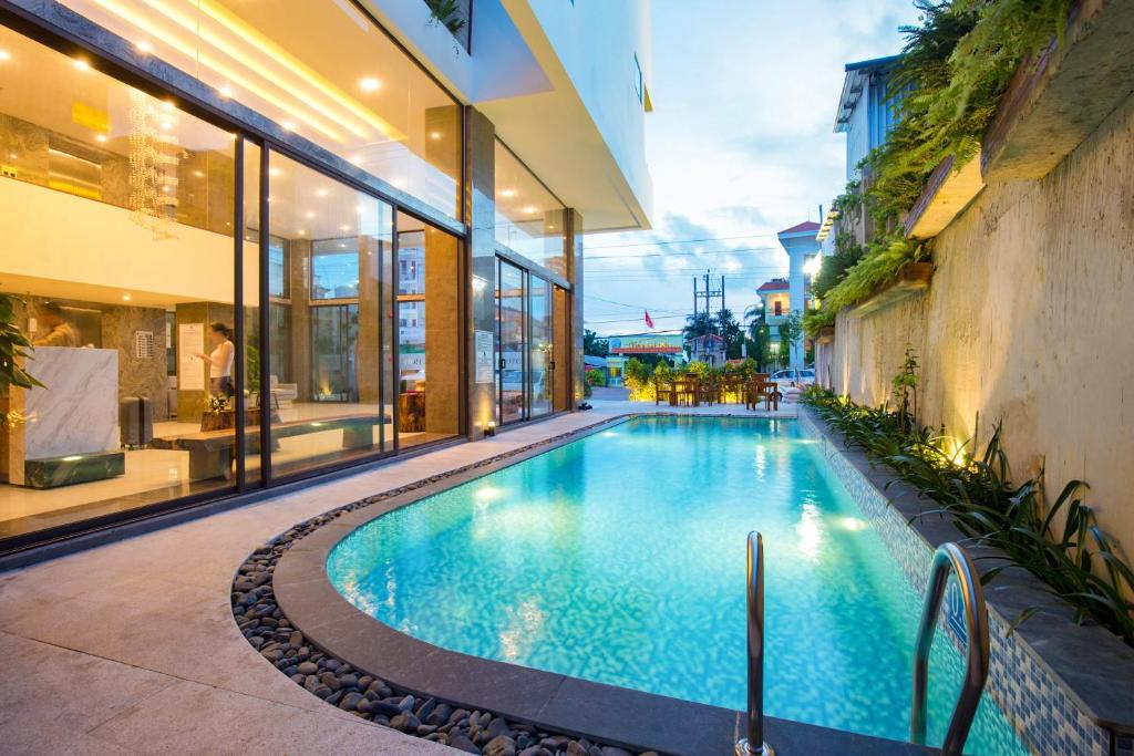 a swimming pool in the middle of a building at Gaia Hotel Phu Quoc in Phu Quoc
