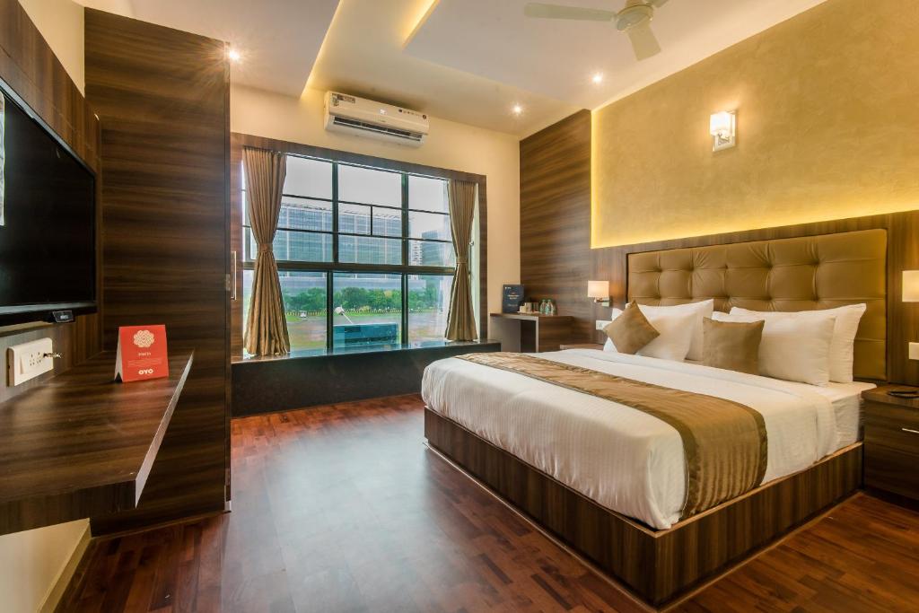 a bedroom with a large bed and a large window at Hotel BKC Inn Near Trade Center, Visa Consulate in Mumbai