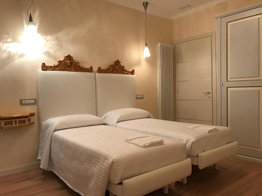 a bedroom with two beds in a room at Hotel "La Salute" in Monte Grimano Terme