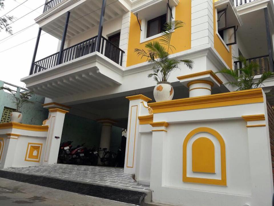 Edificio amarillo y blanco con balcón en Dj Villa, en Pondicherry