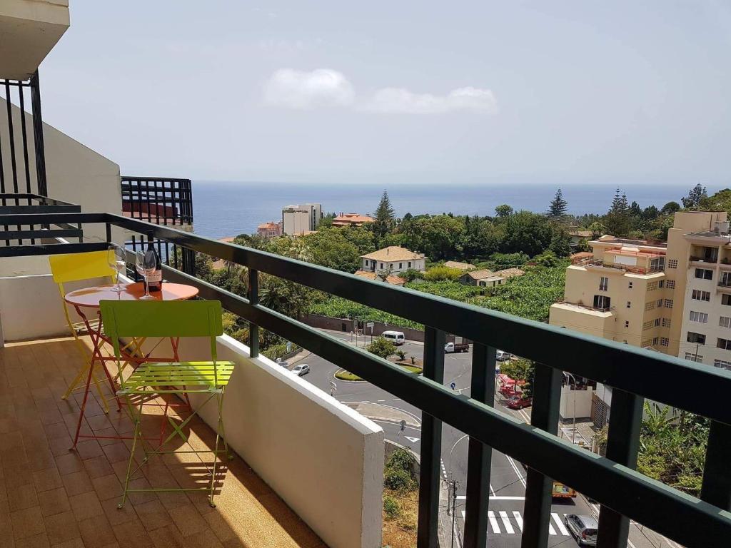 a balcony with a table and chairs and the ocean at Magnolia Apartment in Funchal