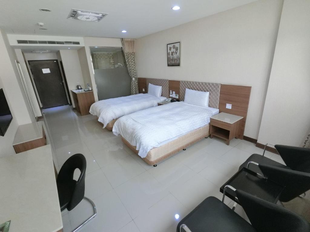 เตียงในห้องที่ 雲林斗六福爾摩莎大飯店