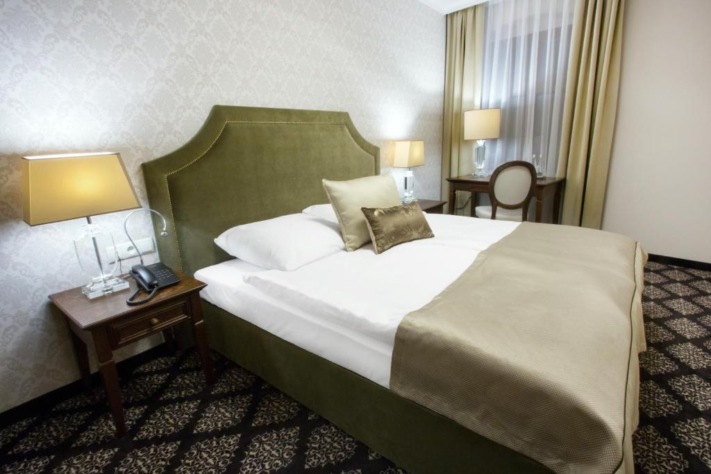 Postel nebo postele na pokoji v ubytování HG Hotel
