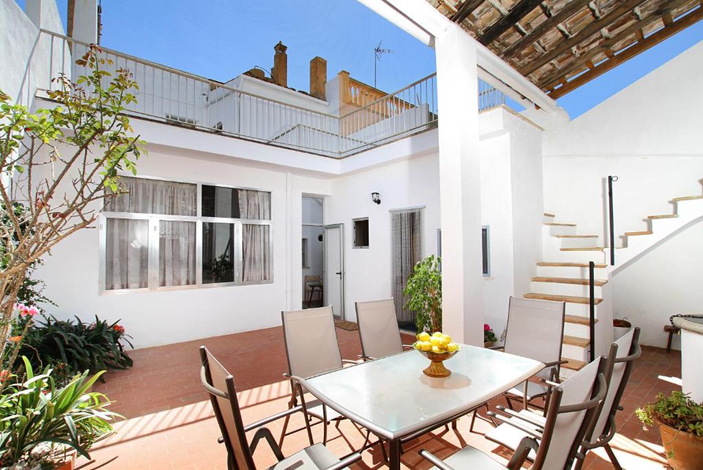 a patio with a white table and chairs at Ca'n Claret in Llucmajor