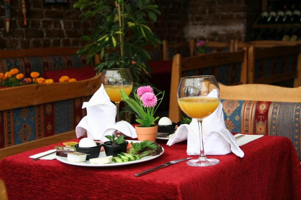 un tavolo con un piatto di cibo e due bicchieri di vino di Istanbul Hotel&Guesthouse a Istanbul