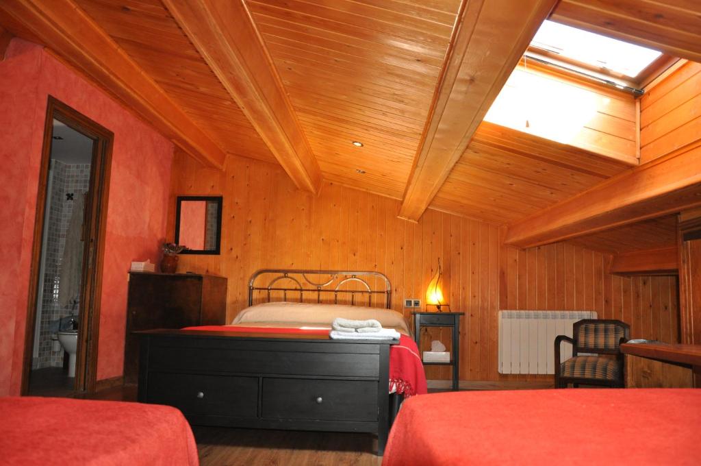 a bedroom with two beds and a skylight at La Posada del Arba in El Frago