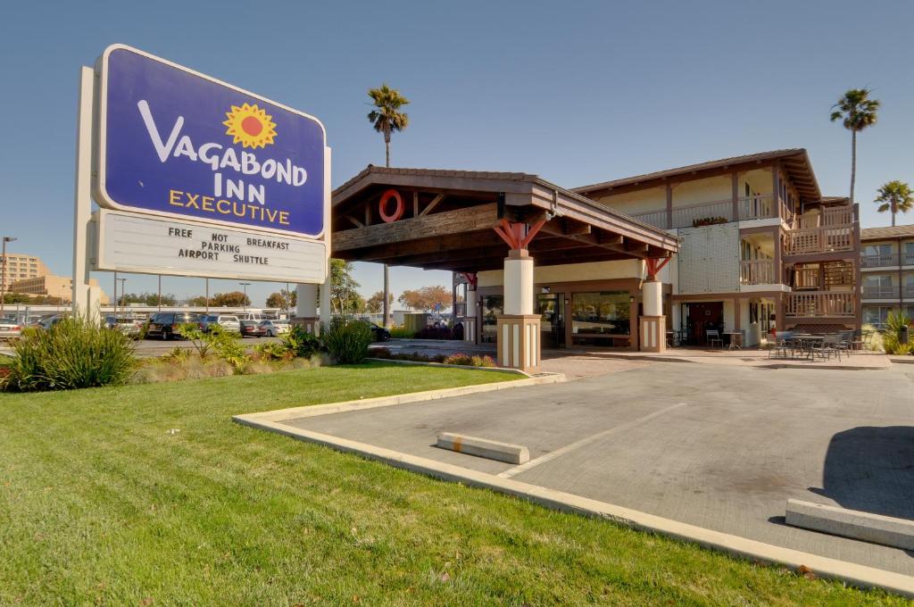 a parking lot with a large sign on the side of the road at Vagabond Inn Executive SFO in Burlingame