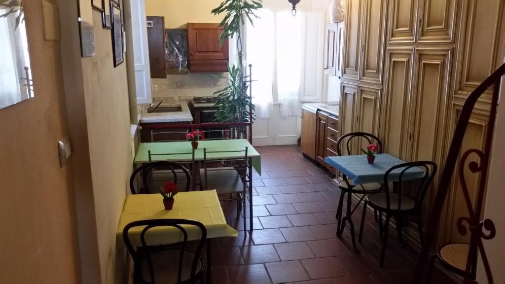 a kitchen with two tables and chairs in a kitchen at Grandpa Mau in Lucca