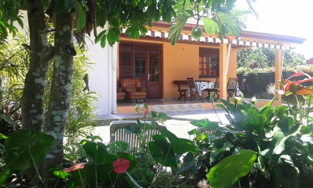 a house with a porch and a patio at Holiday Home Villa Kay Malouz in Saint-Joseph