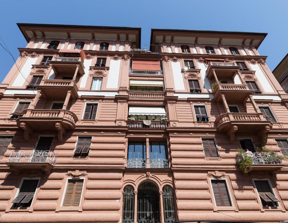 a tall building with windows and balconies on it at Suite Royal in La Spezia