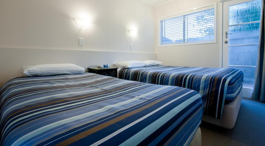 Postel nebo postele na pokoji v ubytování Outrigger Motel