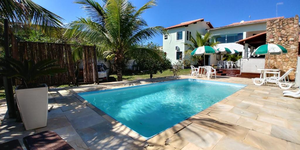 a swimming pool in the backyard of a house at Pousada Santa Monica in Saquarema