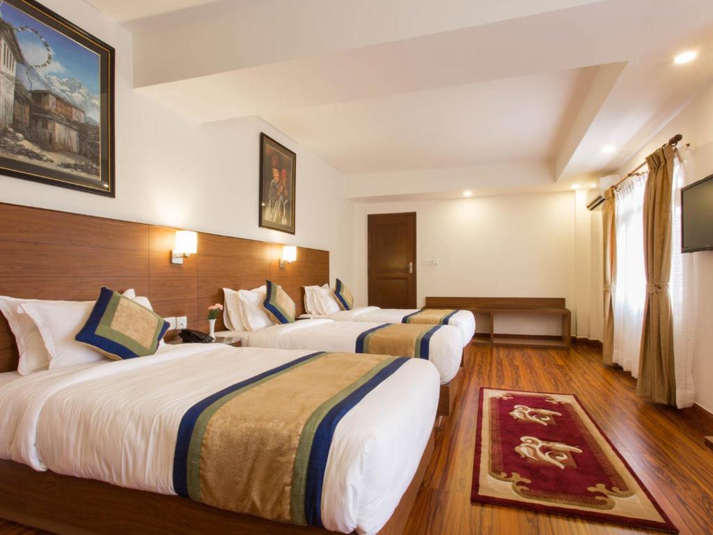 Postel nebo postele na pokoji v ubytování Oasis Kathmandu Hotel