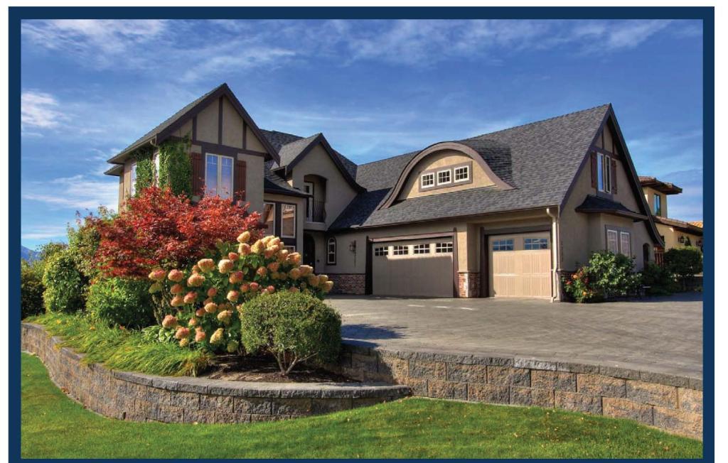 a large house with a large driveway at Cheers B&B in West Kelowna