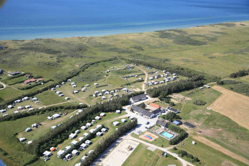 an aerial view of a parking lot next to the water at Gl. Klitgaard Camping & Cottages in Løkken