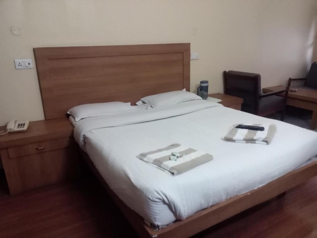 Postel nebo postele na pokoji v ubytování Hotel Preethi Palace