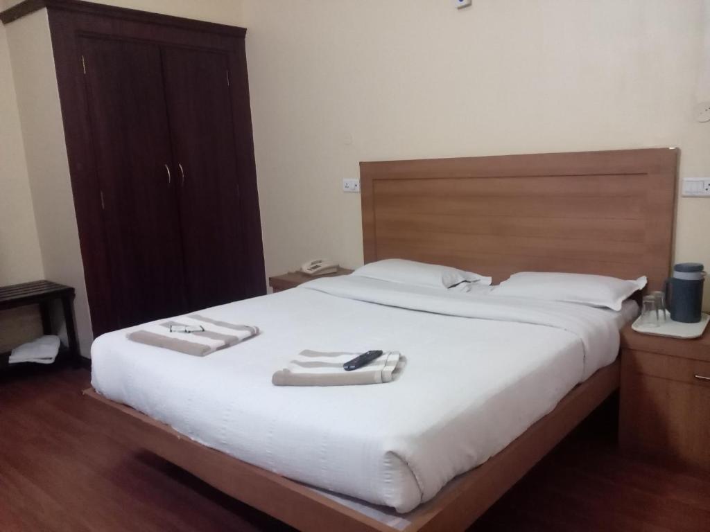 Postel nebo postele na pokoji v ubytování Hotel Preethi Palace