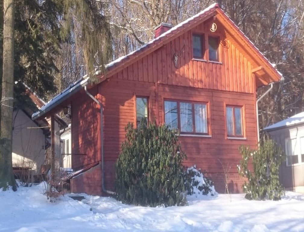 a log cabin in the snow in the woods at Feriendorf "Am Forsthaus" Mosbach in Mosbach