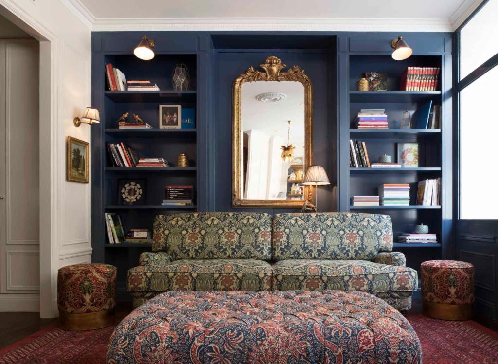 a living room filled with furniture and a bookcase at Maison Malesherbes in Paris