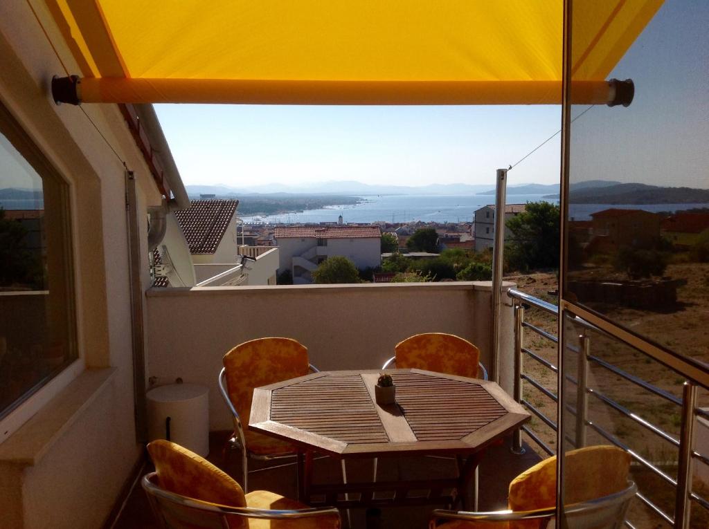 a table and chairs on a balcony with a view at Panorama in Vodice