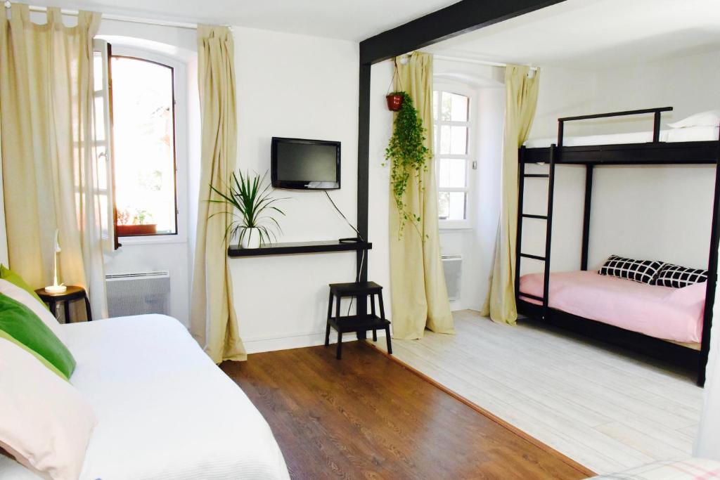 a bedroom with two bunk beds and a tv at Barcelo Appart'hotel in Barcelonnette