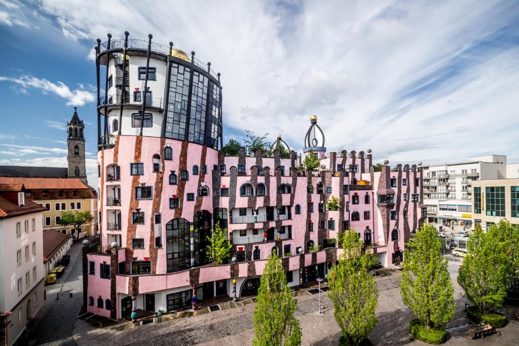 a pink building with a tower on top of it at artHOTEL Magdeburg in Magdeburg