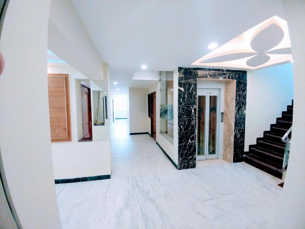 a hallway of a house with a staircase at Hotel Raams Park in Tiruchchirāppalli