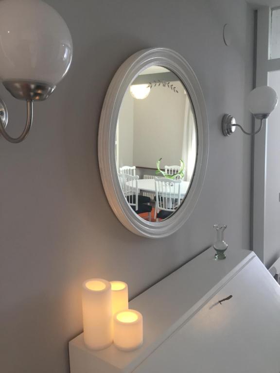 a bathroom with a mirror and candles on a counter at Getxo, parking, wifi, metro in Getxo