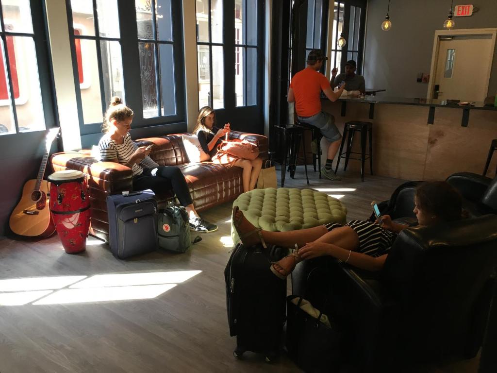 a group of people sitting in a waiting room at Apple Hostels of Philadelphia in Philadelphia