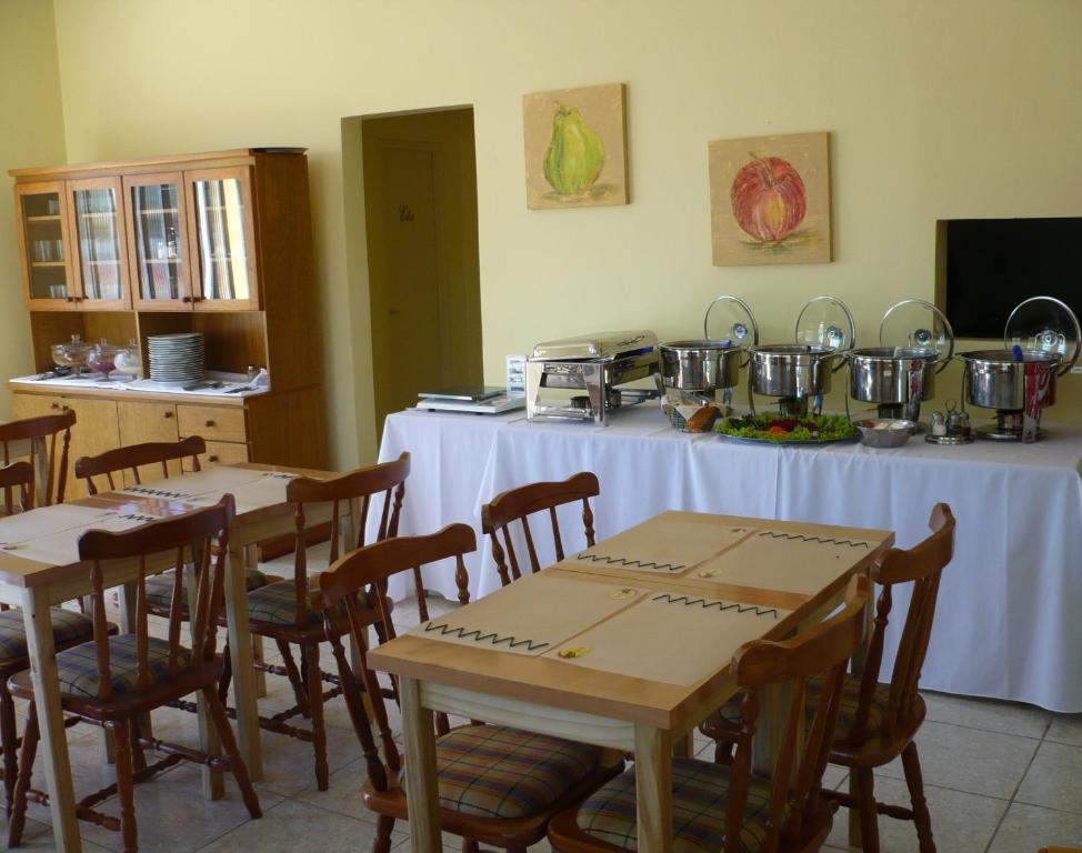 a restaurant with tables and chairs with pots and pans at Guilet Hotel in São Borja