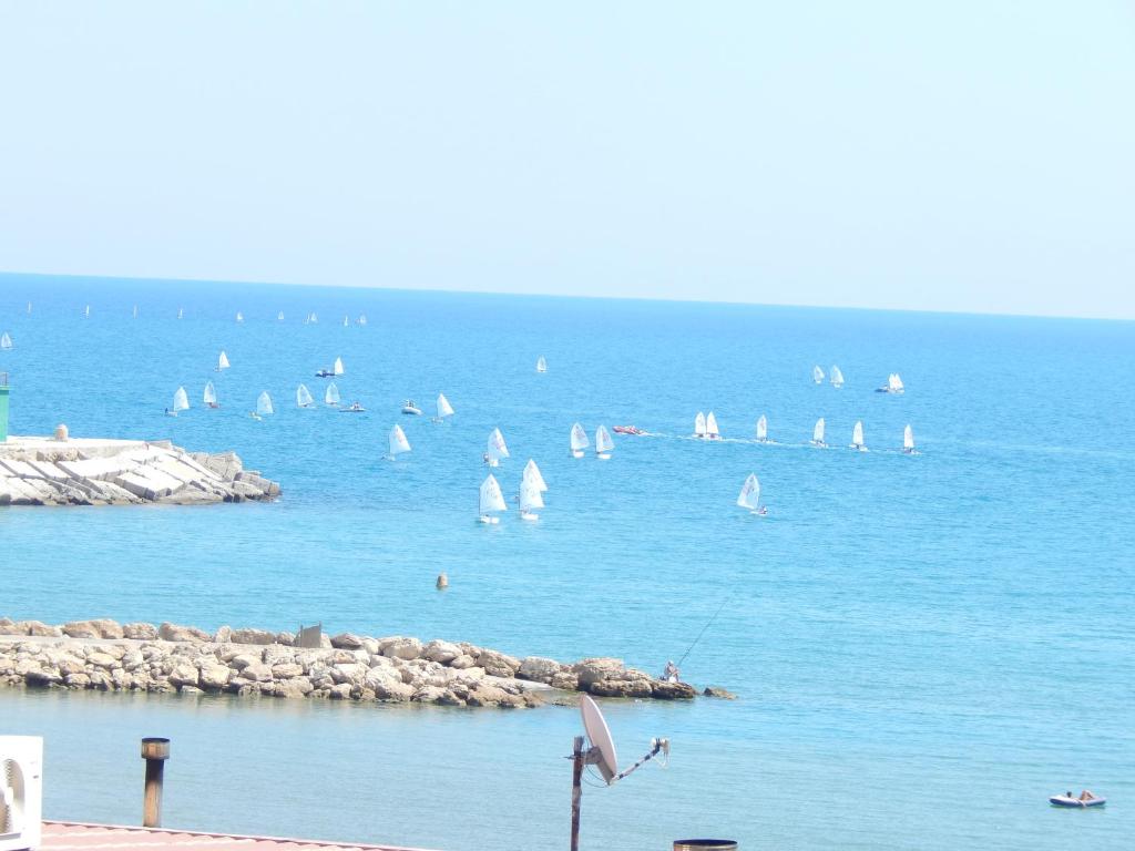 a group of sail boats in the water with people at Montefusco in Crotone