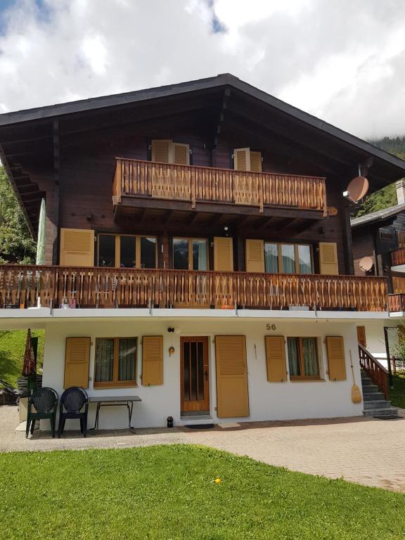 a large house with a balcony on top of it at Ferienwohnung Duinli in Fiesch
