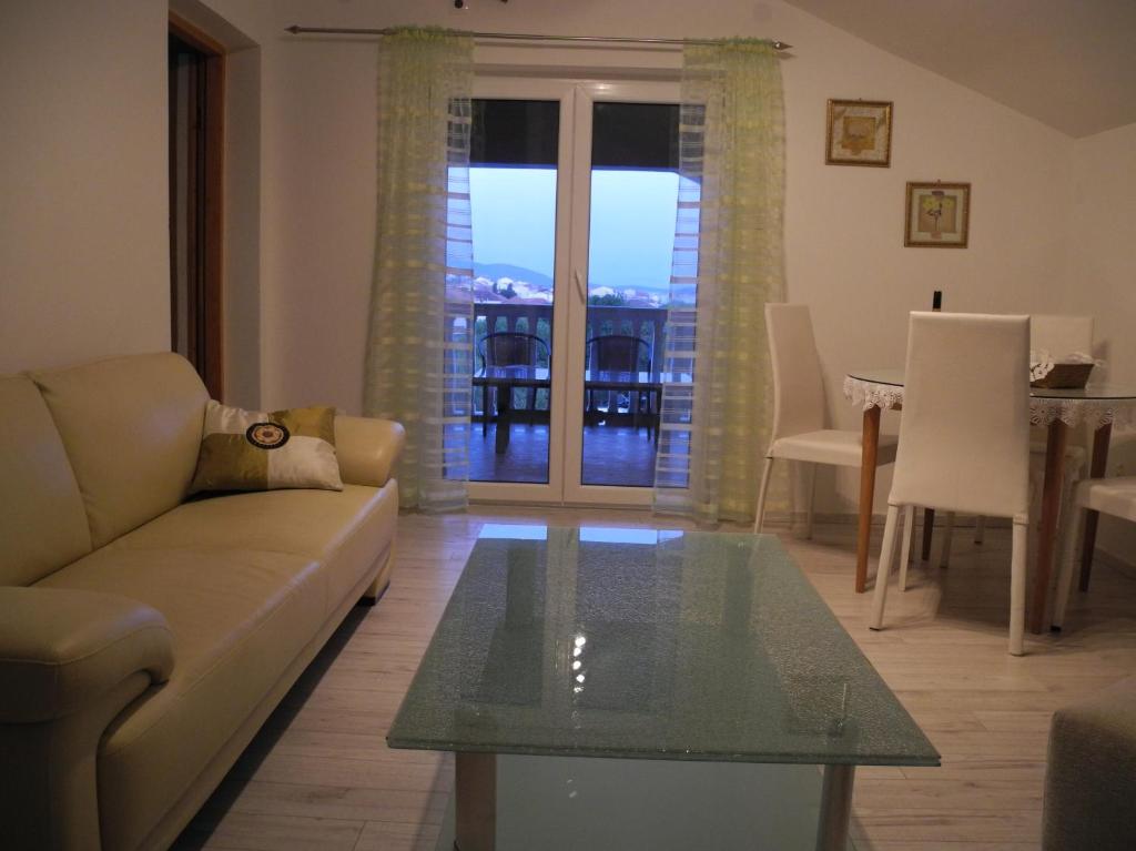 a living room with a couch and a glass table at Villa Ines in Jezera