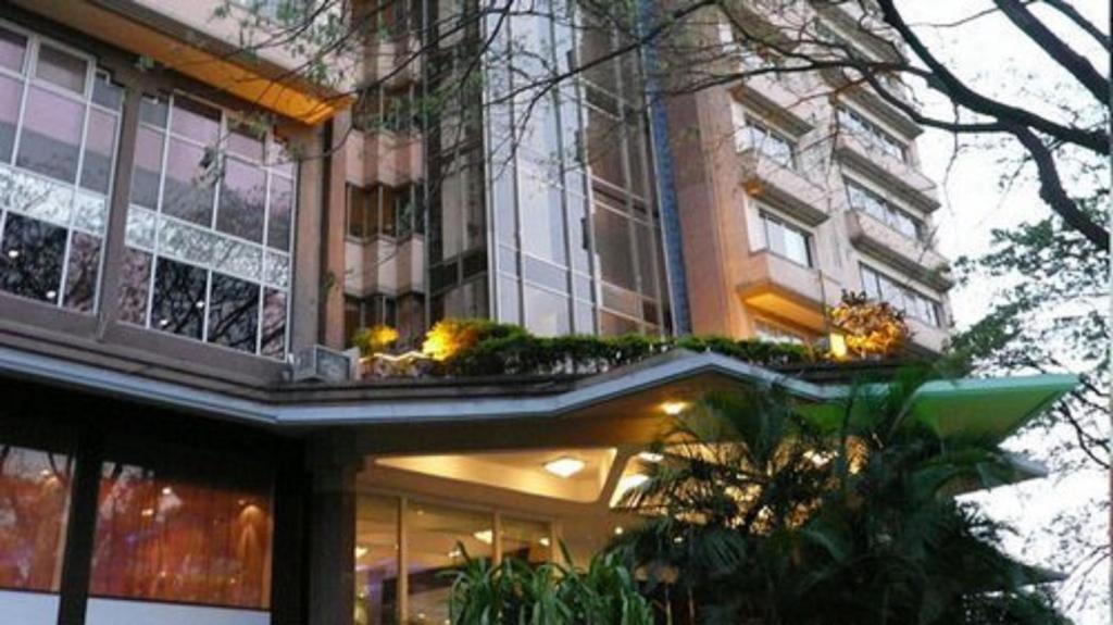 a building with a balcony with plants on it at Royal Orchid Central Bangalore, Manipal Centre, MG Road in Bangalore