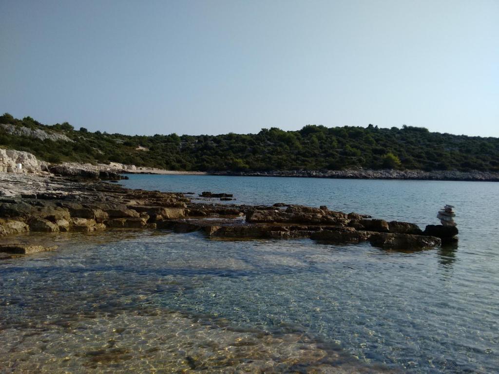 a body of water with rocks in the water at Villa Ines in Jezera