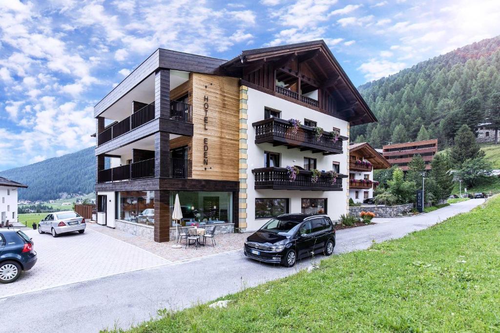 a house with a car parked in front of it at Hotel Eden in Solda