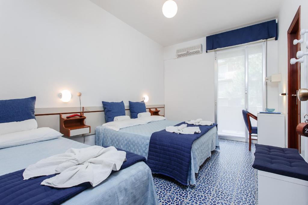 Postel nebo postele na pokoji v ubytování Hotel San Pietro