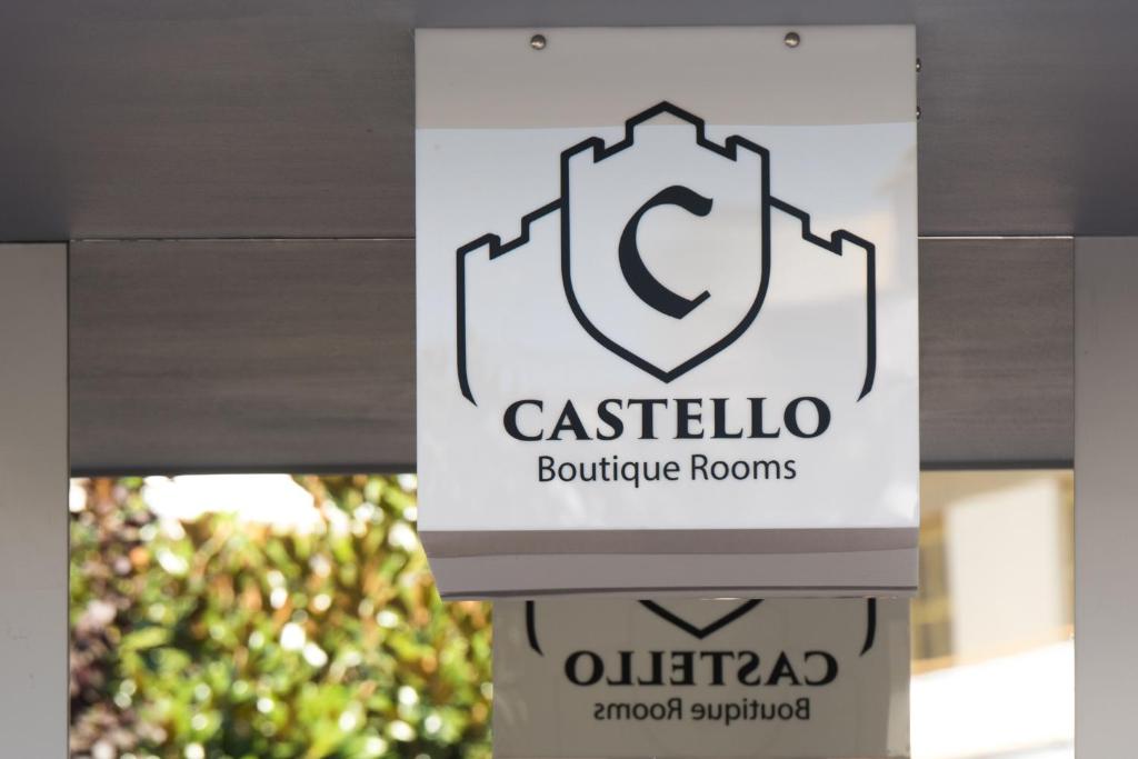 a sign for a building at Castello Boutique Rooms in Kavála