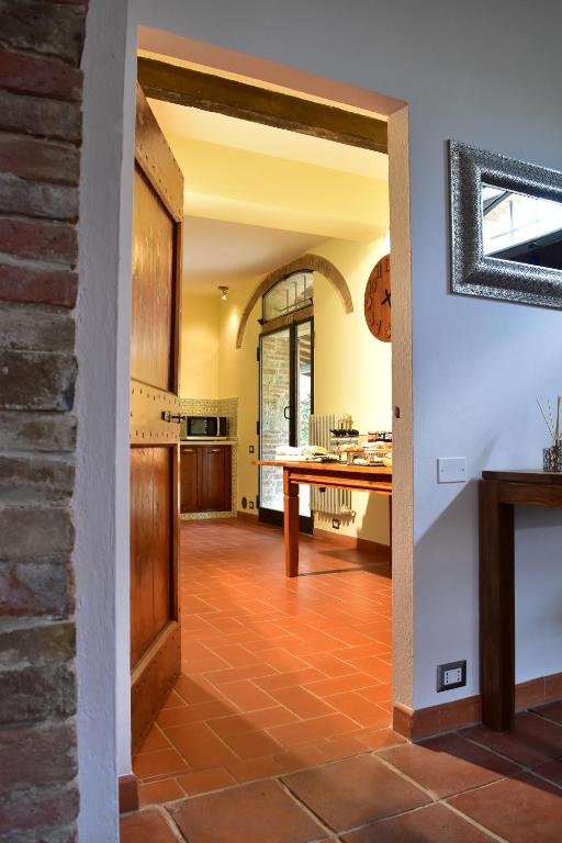 an open kitchen and dining room with a brick wall at Villa San Michele in Barberino di Val dʼElsa