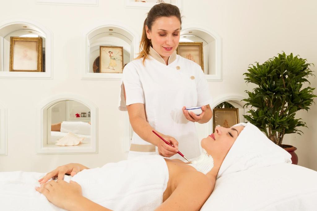 a woman in a spa getting a massage at Grand Hotel Ambasciatori in Sorrento