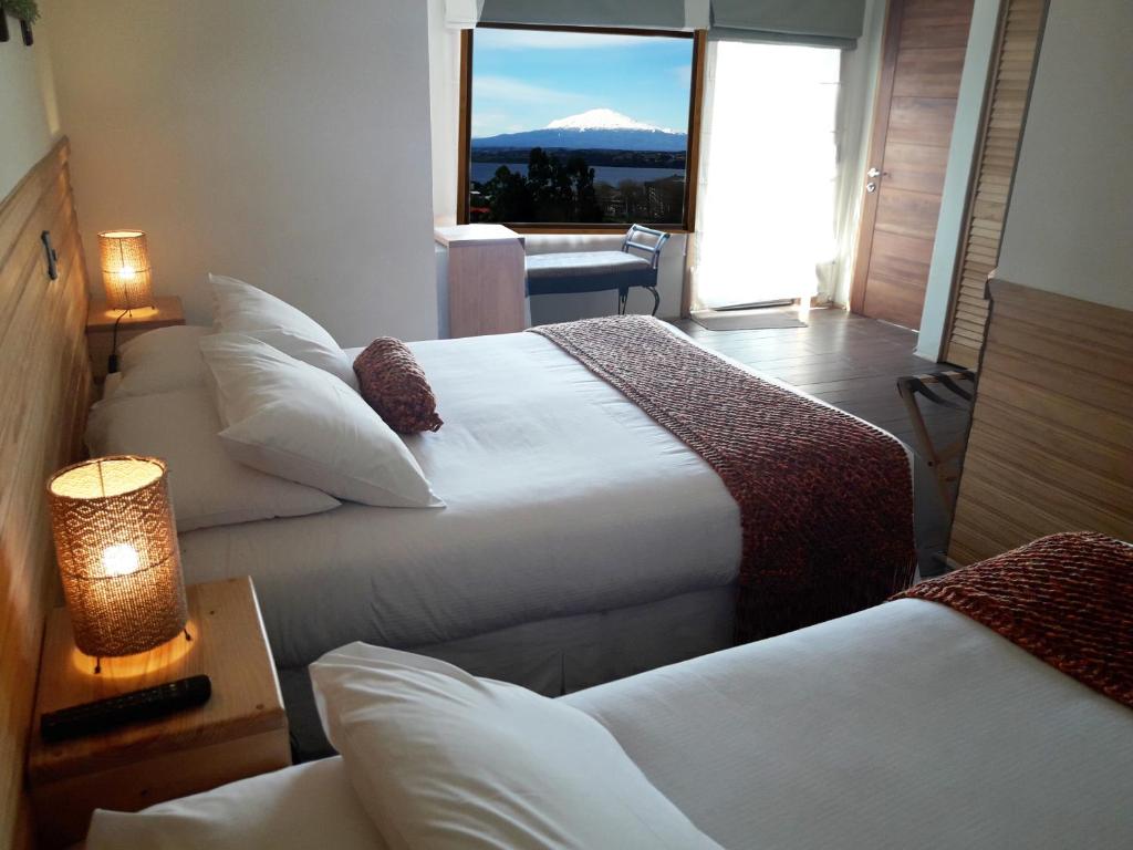 Postel nebo postele na pokoji v ubytování Dein Haus Hotel y Departamentos
