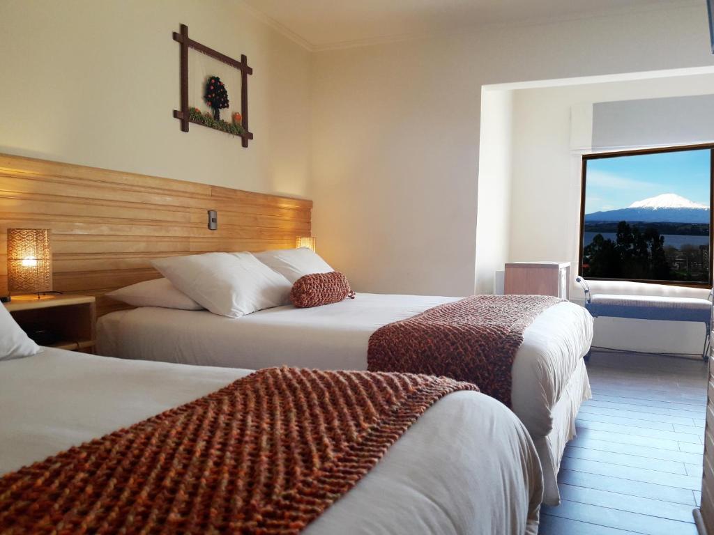 Postel nebo postele na pokoji v ubytování Dein Haus Hotel y Departamentos