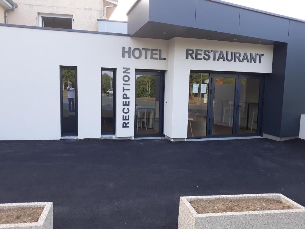 a hotel with a sign on the front of a building at La Godinière in Cholet