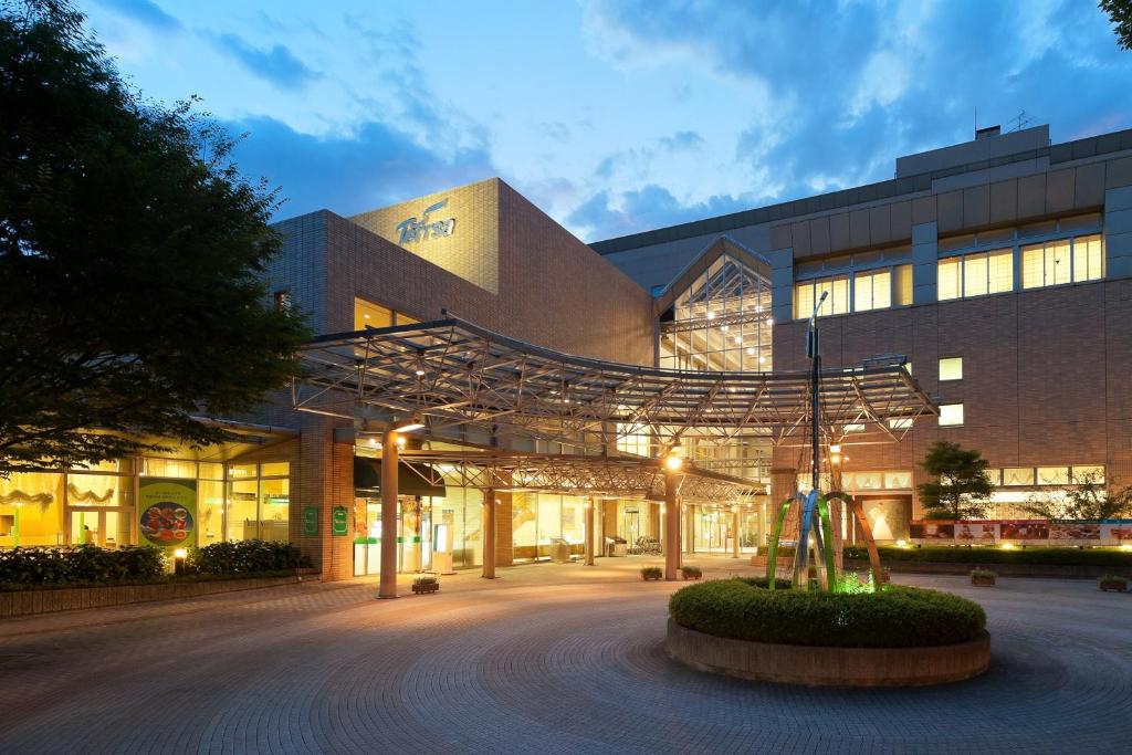 a large building with a large metal structure in front of it at Hotel Kumamoto Terrsa in Kumamoto