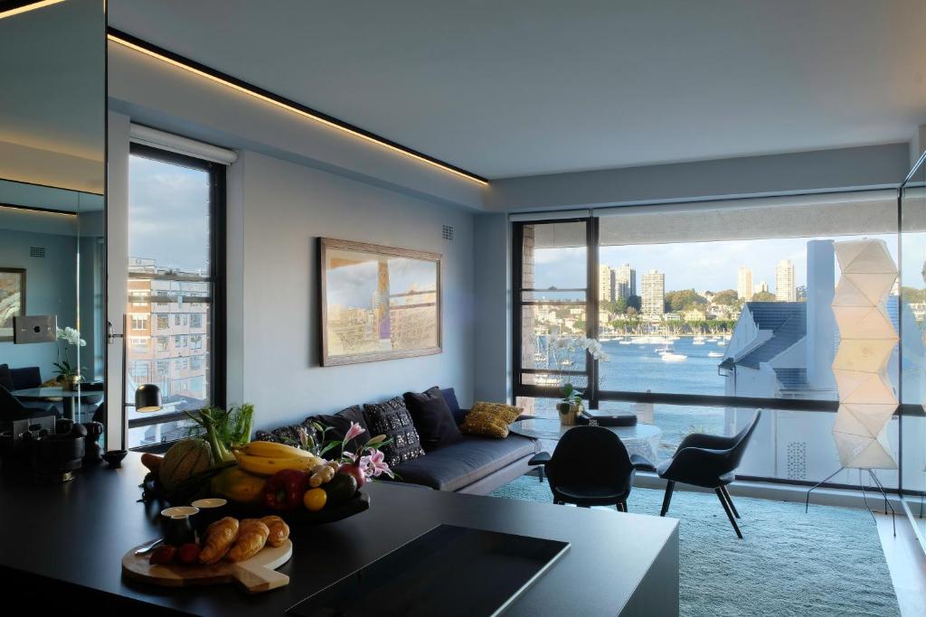 a living room with a couch and a table at The KC Elizabeth Bay in Sydney