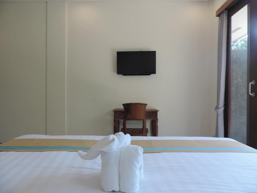 Postel nebo postele na pokoji v ubytování Kencana Ubud by Mahaputra