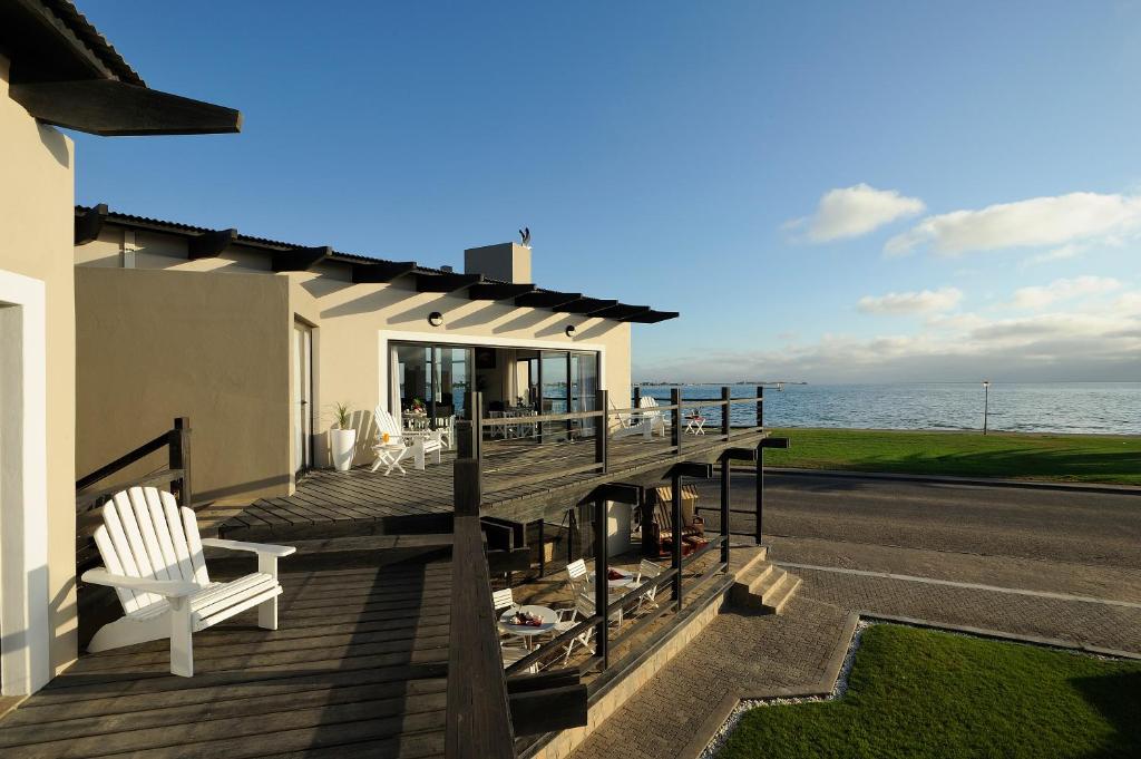 a house with a deck with a view of the ocean at Oyster Box Guesthouse in Walvis Bay