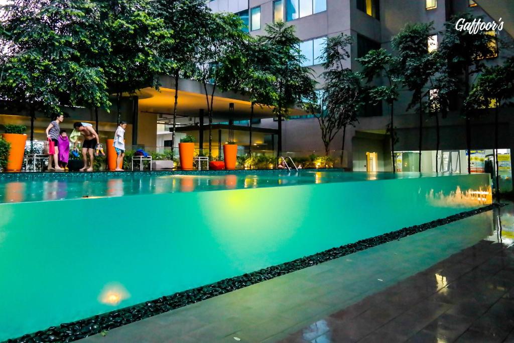 an empty swimming pool in front of a building at Resort Hostel In City in Kuala Lumpur