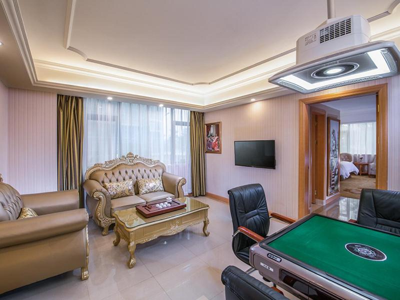 a living room with a pool table in a room at Vienna International Hotel Puning International Commodity City in Puning